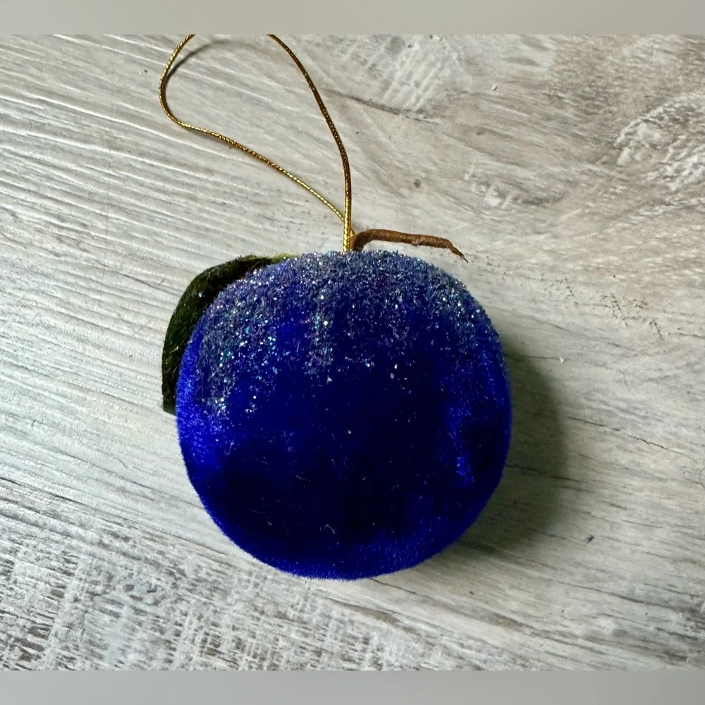 Christmas tree ornament. A plum-shaped ornament covered in glitter. The ornament